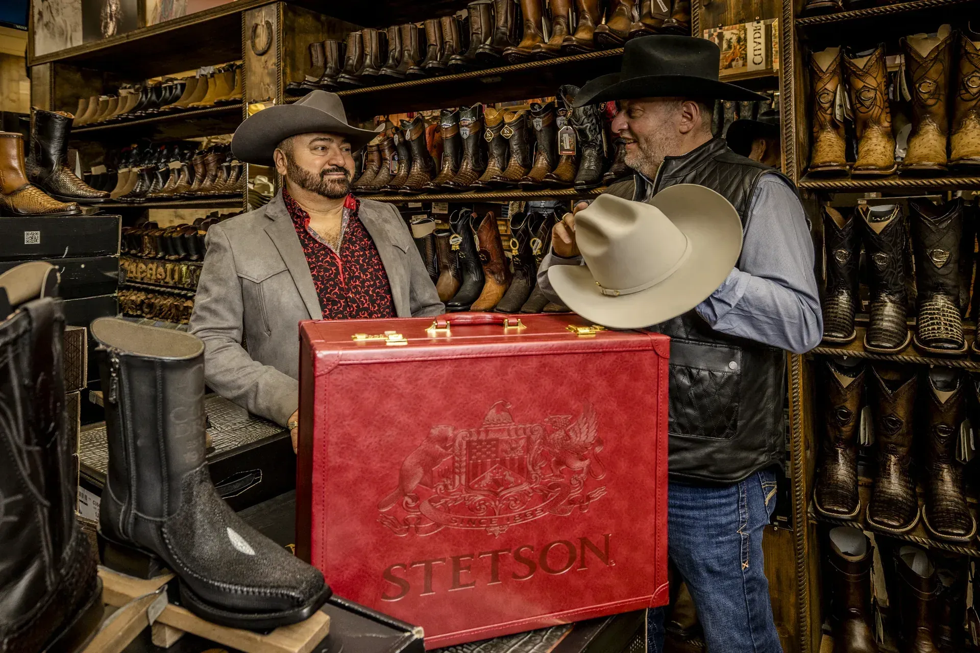 Men in leather jackets and cowboy hats with Stetson hat cases at El Alazán
