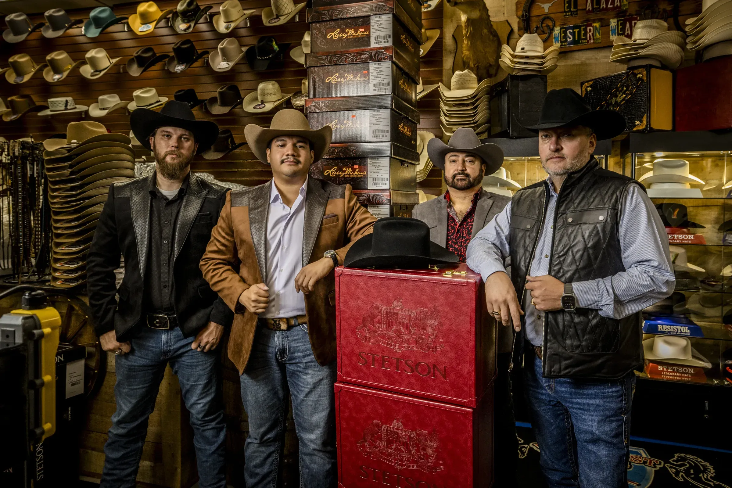 The El Alazán team in cowboy hats with red Stetson hat cases